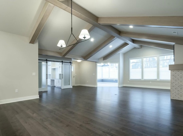 unfurnished living room featuring an inviting chandelier, dark hardwood / wood-style floors, lofted ceiling with beams, and a barn door