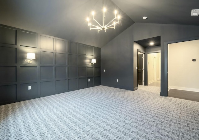 carpeted empty room with lofted ceiling and a notable chandelier