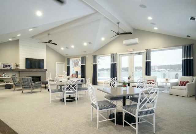 dining room with beam ceiling, a wall unit AC, french doors, and ceiling fan