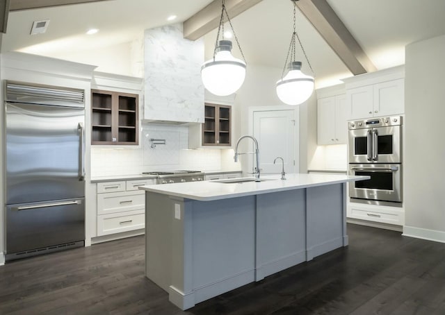 kitchen with sink, white cabinetry, decorative light fixtures, a center island with sink, and appliances with stainless steel finishes