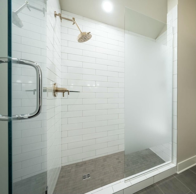 bathroom featuring tile patterned flooring and an enclosed shower