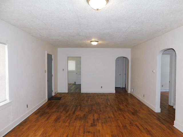 spare room with dark hardwood / wood-style flooring