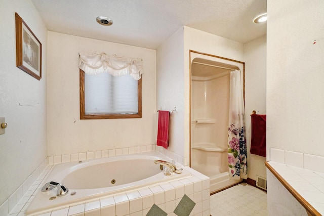 bathroom with vanity and separate shower and tub