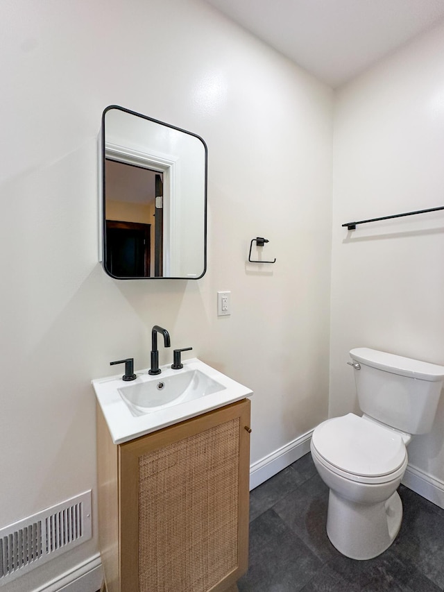 bathroom featuring toilet, tile patterned floors, and vanity