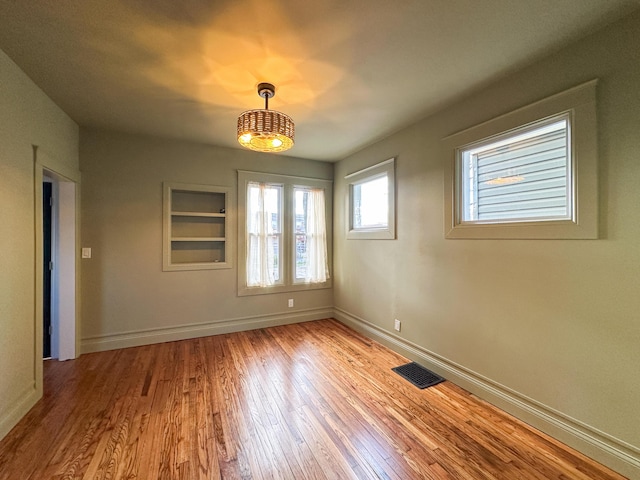 spare room featuring light hardwood / wood-style floors