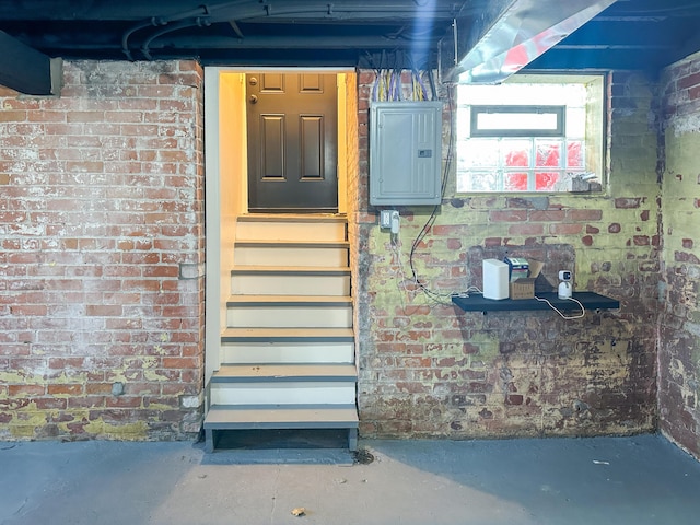 basement with brick wall and electric panel