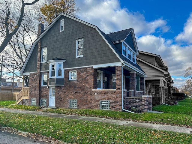 view of home's exterior featuring a porch and a lawn