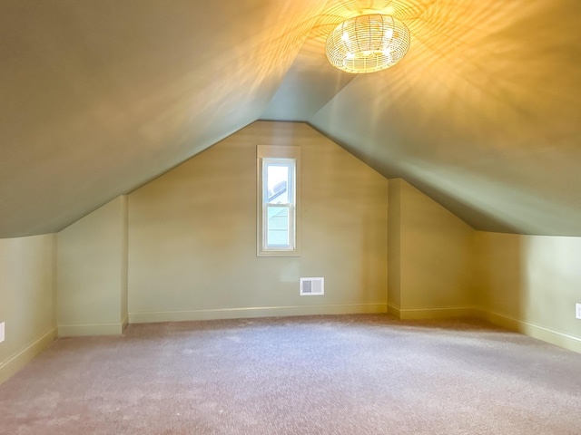 additional living space with light carpet and lofted ceiling