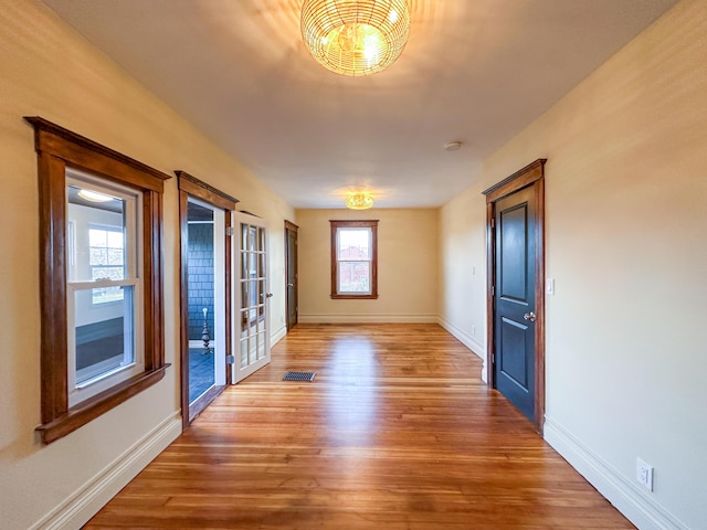 interior space with a healthy amount of sunlight and hardwood / wood-style flooring