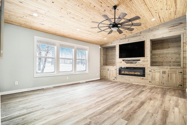 unfurnished living room featuring light wood finished floors, a ceiling fan, a glass covered fireplace, wooden ceiling, and vaulted ceiling