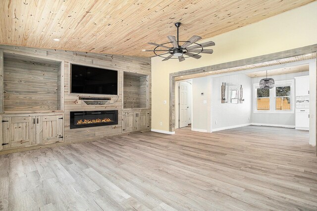 unfurnished living room with a large fireplace, light wood finished floors, baseboards, wood ceiling, and vaulted ceiling