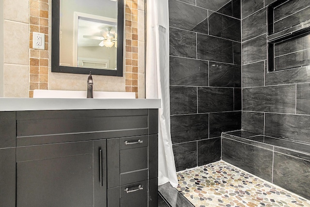 full bath with a shower stall, vanity, and a ceiling fan