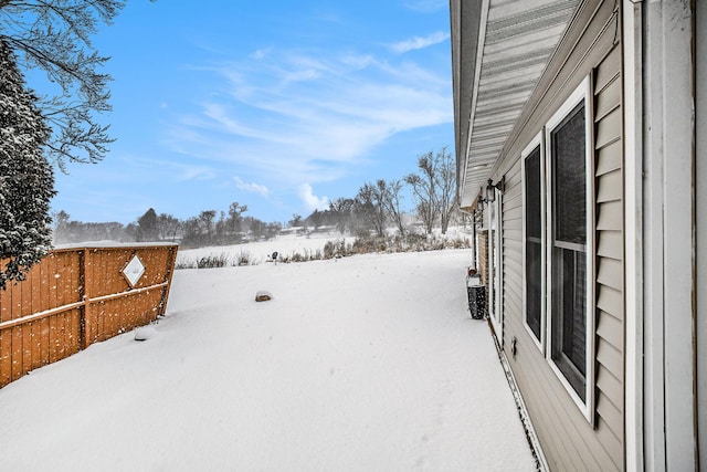 snowy yard with fence