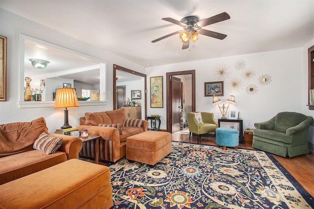 living room with ceiling fan and wood-type flooring