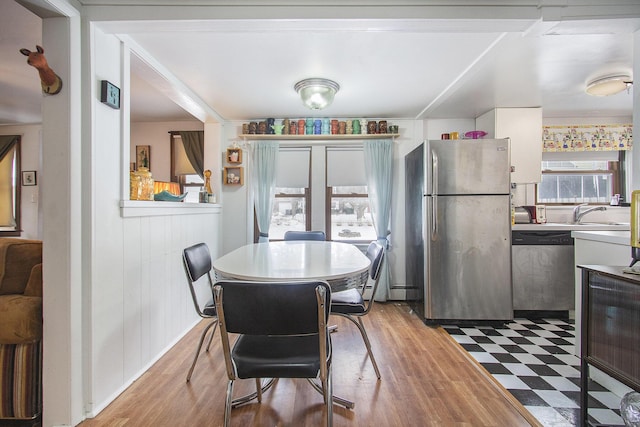 dining room featuring sink and hardwood / wood-style flooring