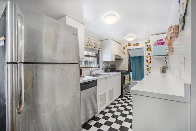 kitchen featuring white cabinetry, appliances with stainless steel finishes, sink, and backsplash