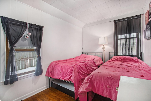 bedroom with dark wood-type flooring