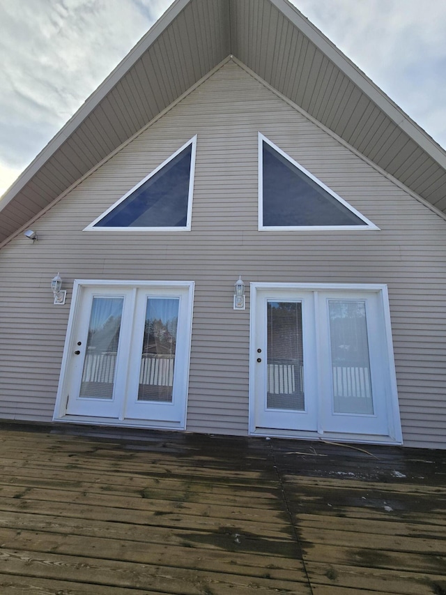 rear view of house featuring a wooden deck