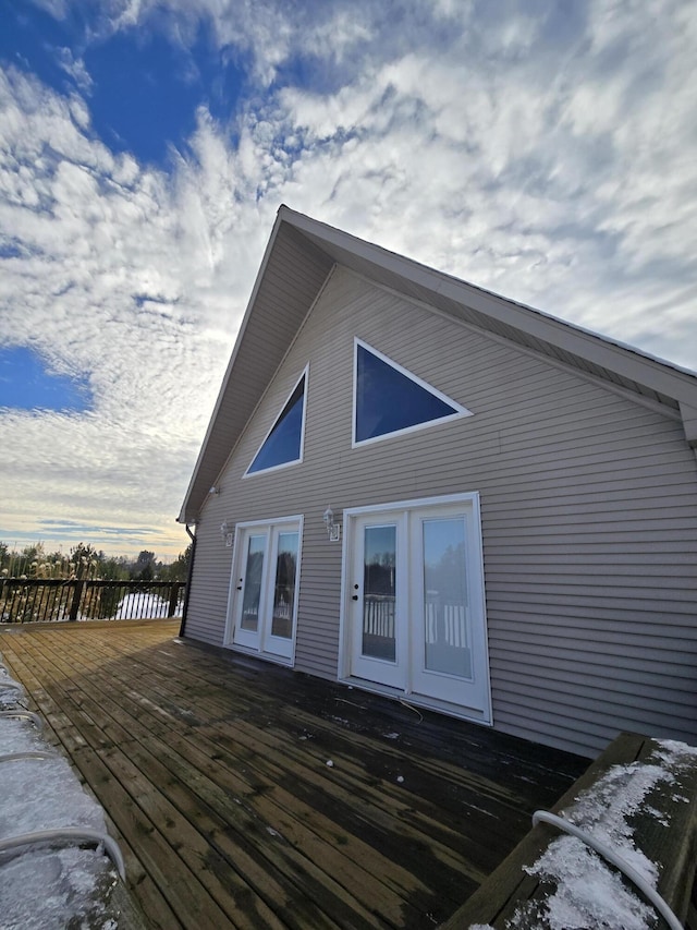 rear view of property featuring a wooden deck