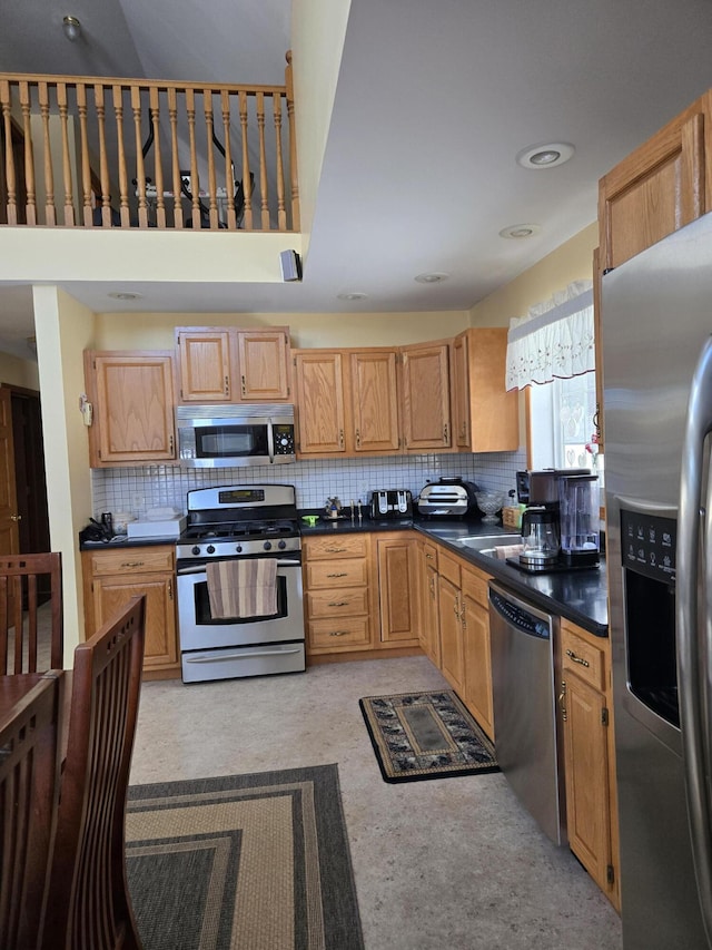 kitchen with backsplash and appliances with stainless steel finishes