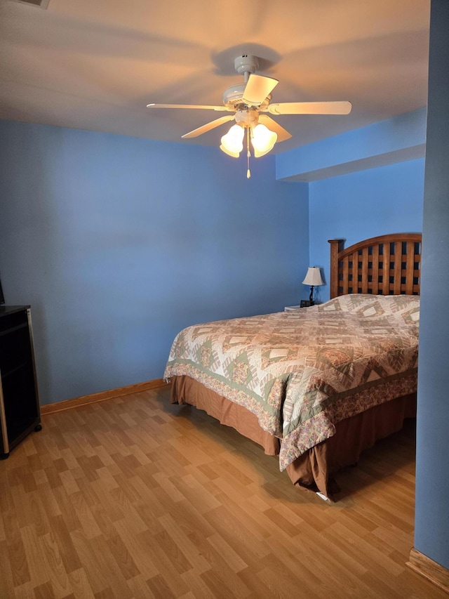 bedroom featuring ceiling fan and light hardwood / wood-style flooring