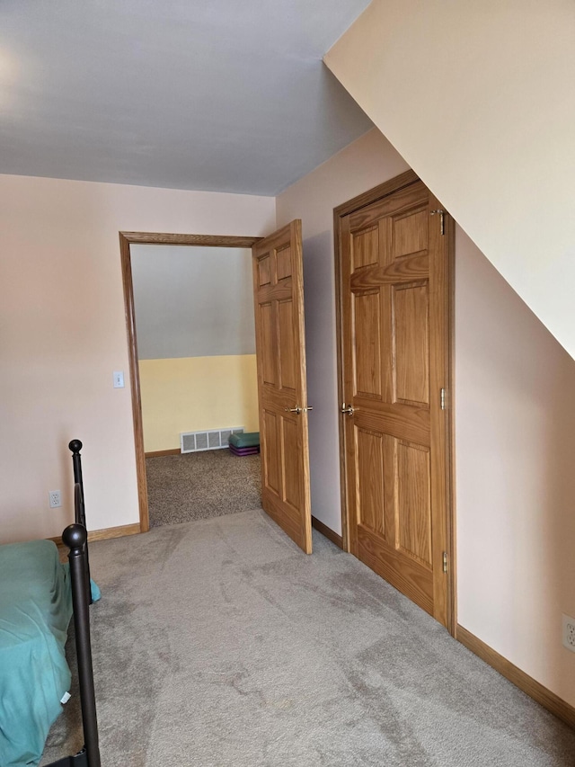 unfurnished bedroom with light colored carpet