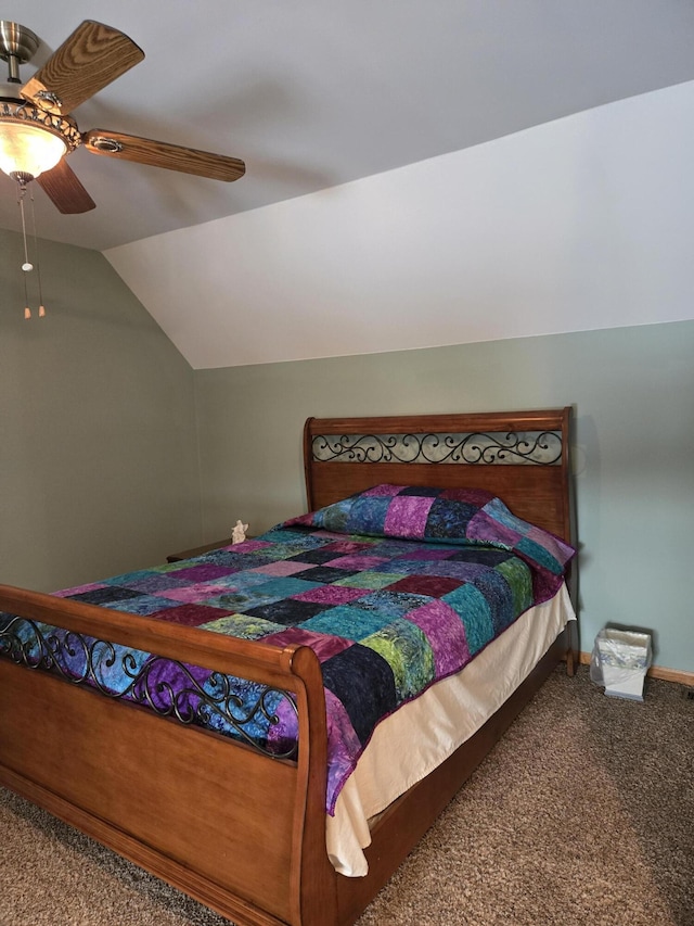 bedroom with ceiling fan, lofted ceiling, and carpet flooring