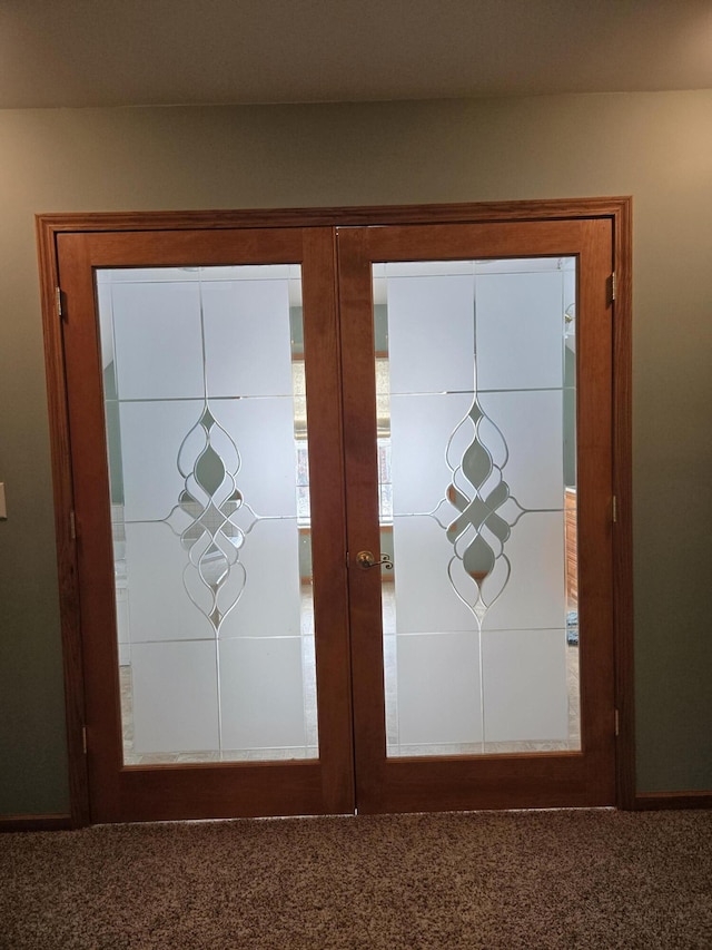 entryway with dark colored carpet and french doors