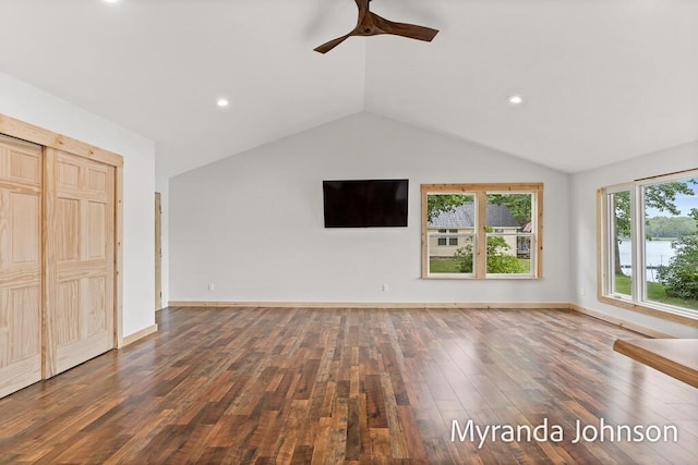 unfurnished living room with ceiling fan, dark wood-type flooring, and lofted ceiling