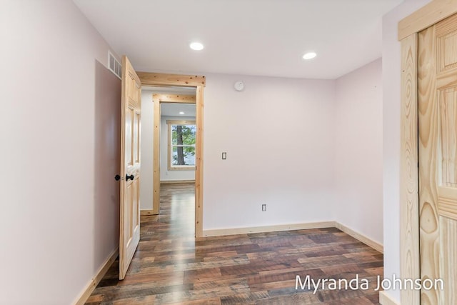 spare room with dark hardwood / wood-style flooring