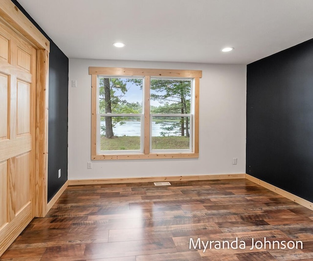 spare room with dark hardwood / wood-style flooring