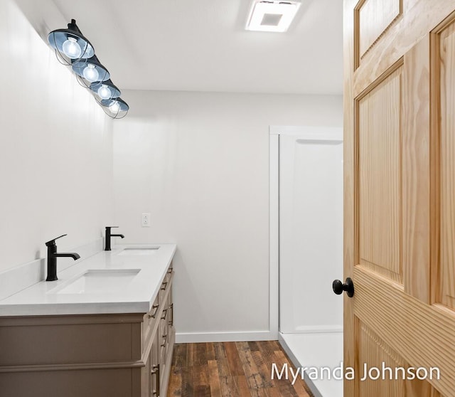 bathroom with hardwood / wood-style floors and vanity