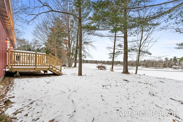 yard covered in snow featuring a wooden deck