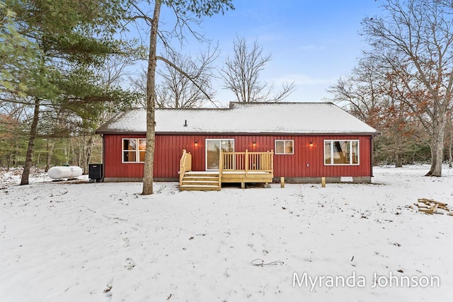 snow covered property featuring a wooden deck