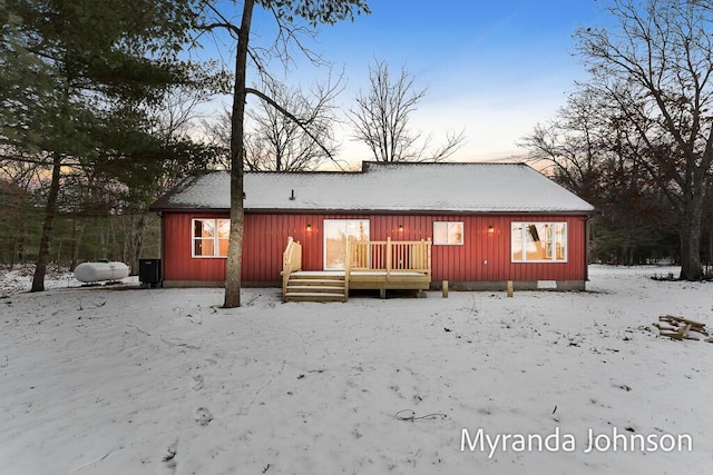 view of snow covered back of property