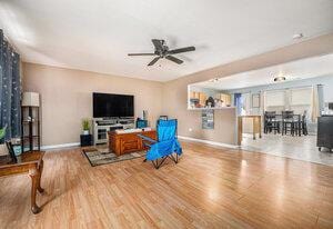 living room featuring ceiling fan, billiards, and wood-type flooring