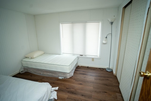 bedroom featuring dark wood-type flooring and multiple windows