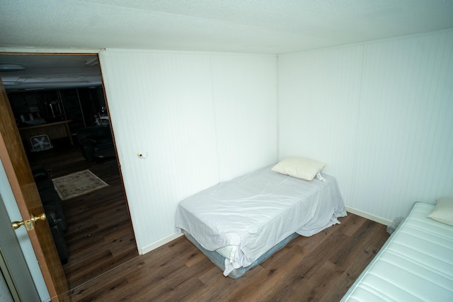 bedroom with pool table and dark hardwood / wood-style floors