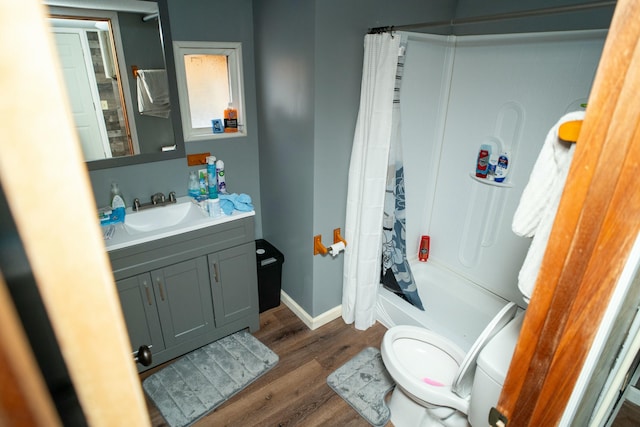 full bathroom with toilet, shower / bath combo, hardwood / wood-style flooring, and vanity