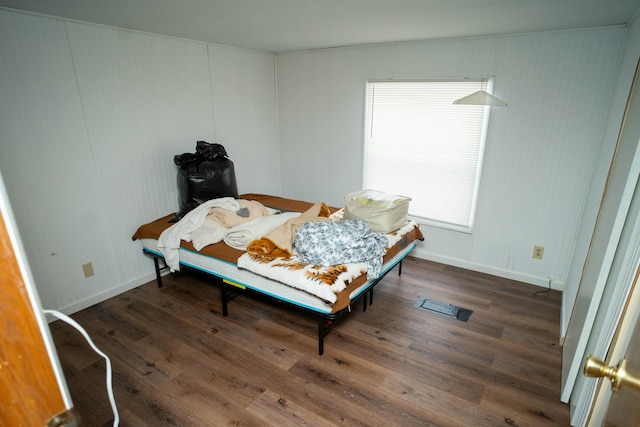 bedroom with dark hardwood / wood-style floors