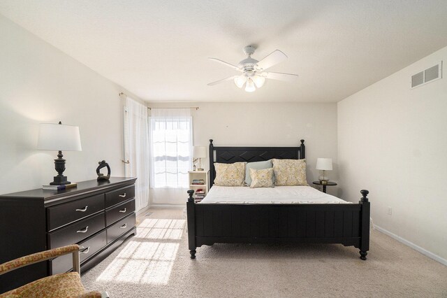 bedroom with ceiling fan and light colored carpet