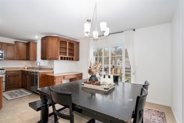 tiled dining space with sink and a chandelier