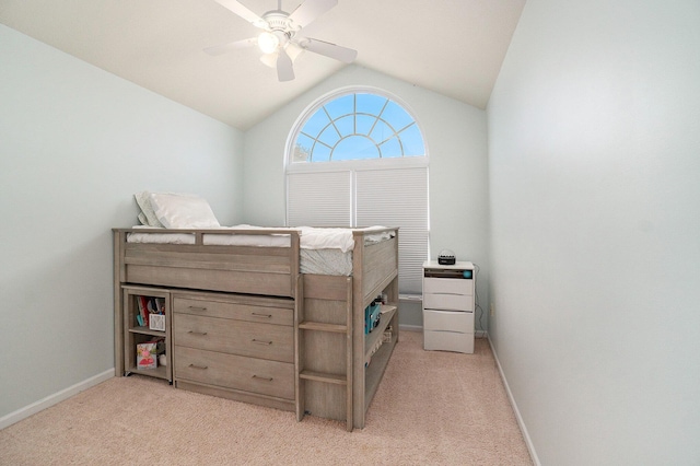 carpeted bedroom with ceiling fan and vaulted ceiling