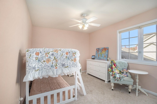 bedroom with ceiling fan and light carpet