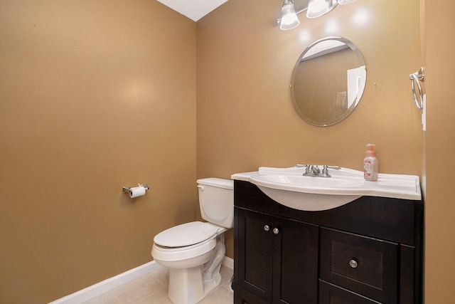 bathroom featuring tile patterned flooring, vanity, and toilet