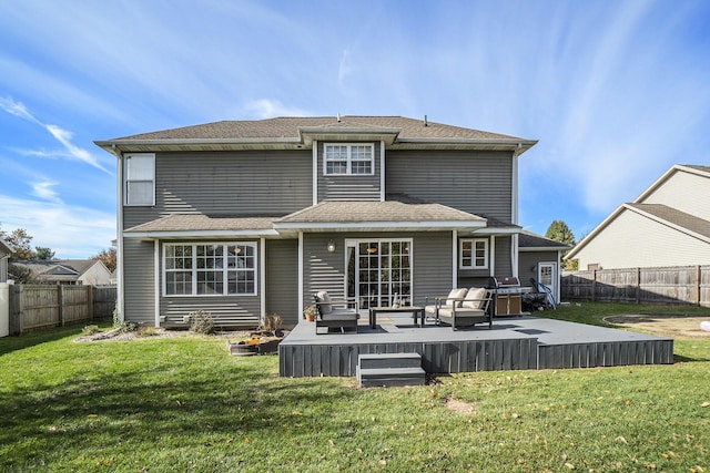 back of property with a lawn, a wooden deck, and outdoor lounge area