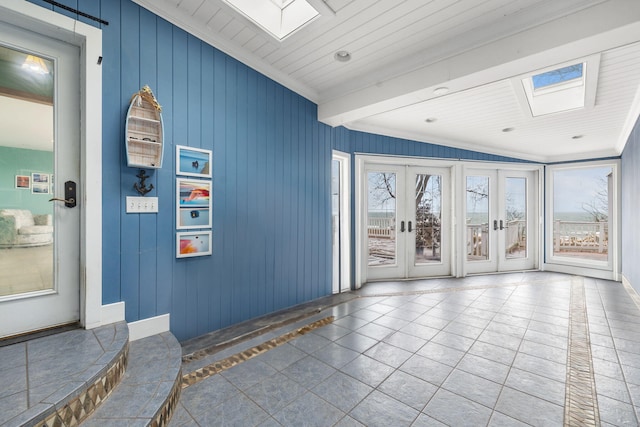 interior space with wood ceiling, a skylight, and crown molding