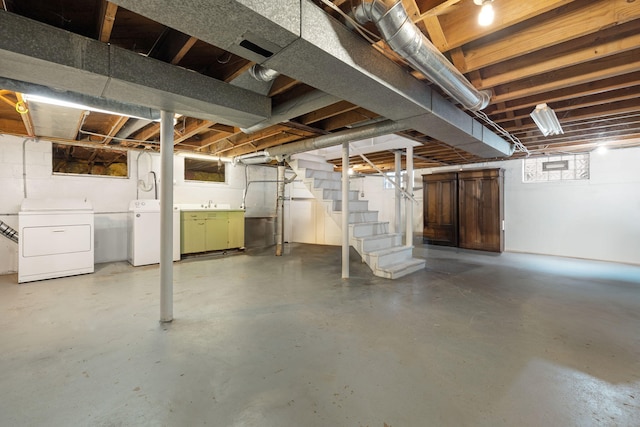 basement with washer and clothes dryer and sink