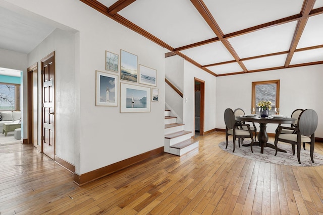 dining space with beamed ceiling, light hardwood / wood-style floors, and coffered ceiling