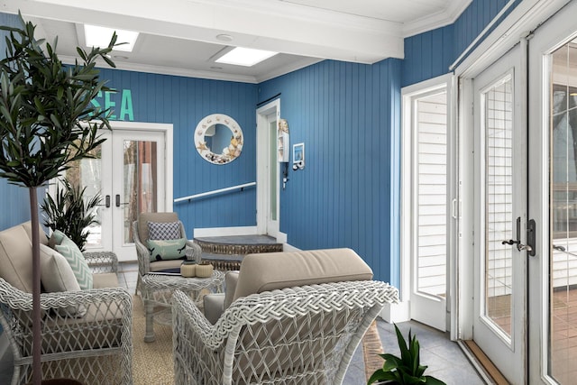 interior space with light tile patterned flooring, french doors, and crown molding